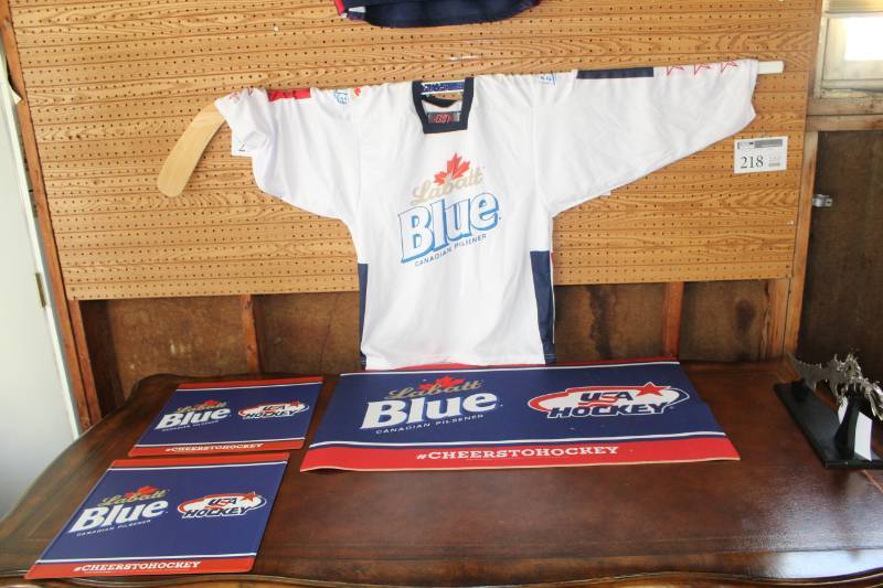 lot 240 image: Labatt Blue Beer Hockey Stick, White Jersey, 2-Signed Tins, Area Rug
