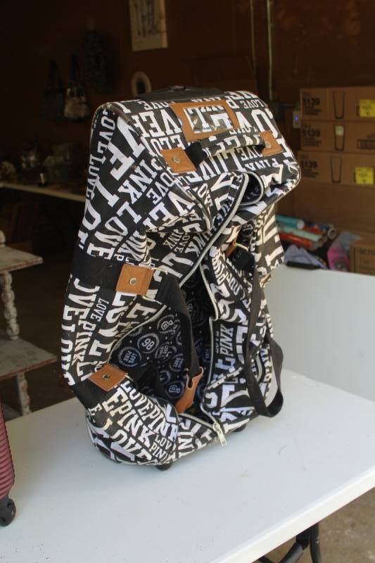lot 251 image: Victoria Secret Pink Love Rolling Luggage