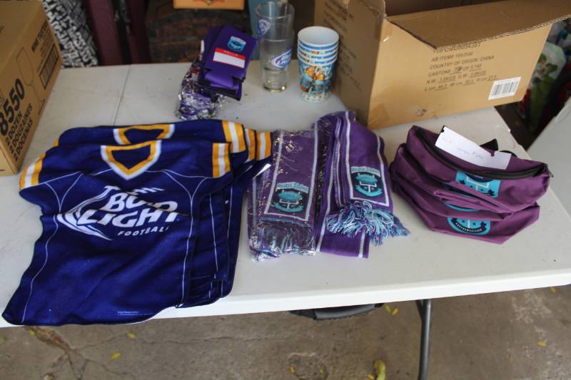 lot 246A image: Bud Light Beer Bottle Coozies, Scarves, Glasses, Plastic Cups, T-Shirt Towels, Fanny Packs