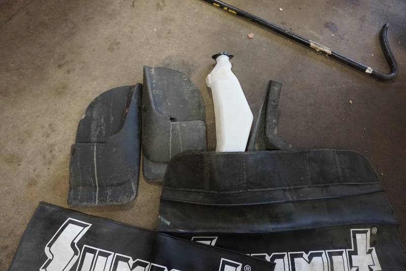 lot 54 image: Set of - 2 Mechanics Fender Guards With Assorted Mud Flaps & Washer Reservoir