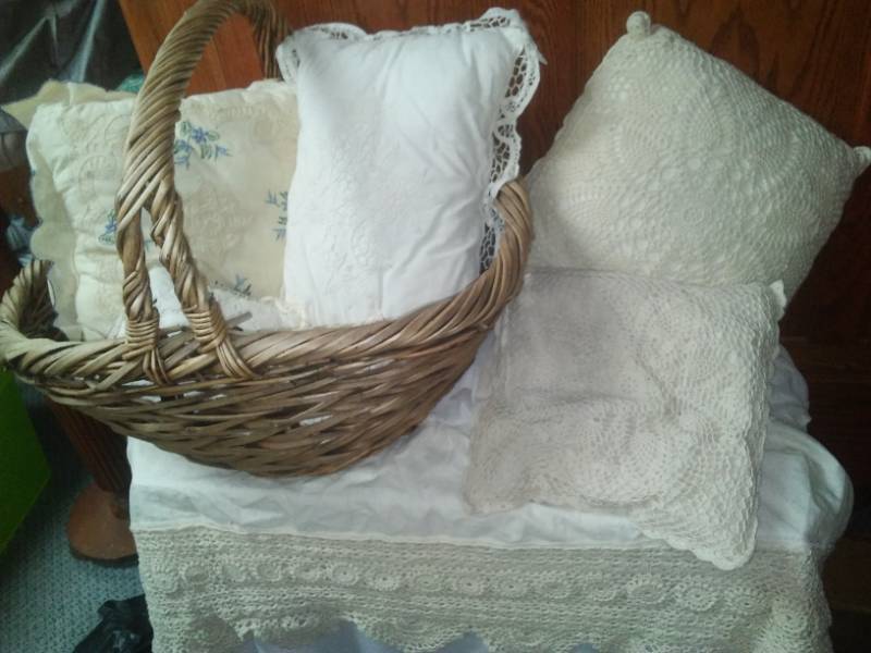 lot 129 image: Lace pillows, bed ruffle and basket.
