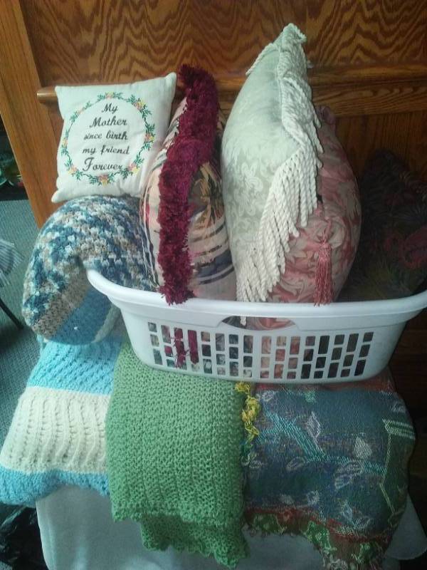 lot 133 image: 4 throw blankets, five pillows and laundry basket all very nice quality.
