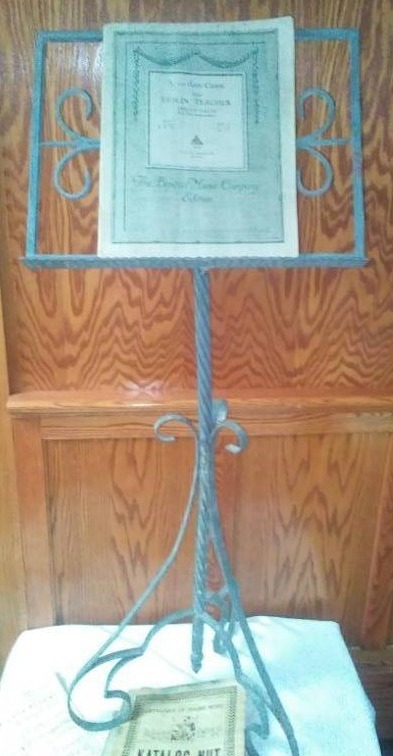 lot 142 image: Cast iron music stand and music.