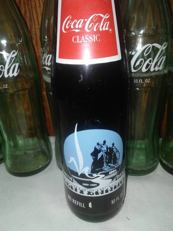 lot 169 image: 9 Coca Cola 10 oz bottles