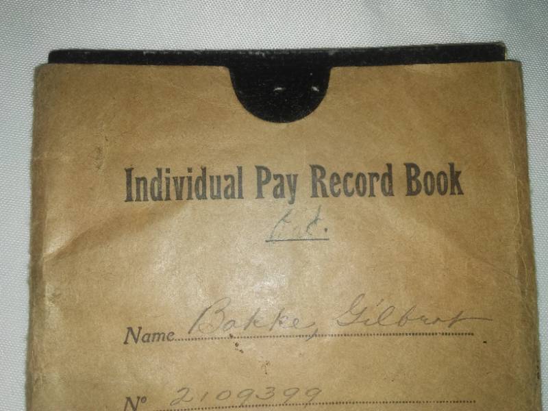 lot 396 image: WWI individual pay record book, Gilbert Bakke. HQ company desk of Paris.