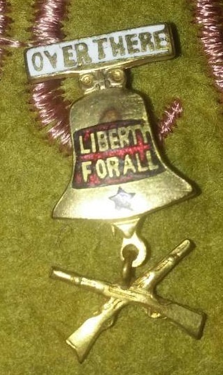 lot 410 image: WWI U. S. Army hanging Banner and over there  pin for democracy.