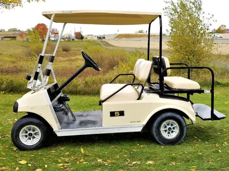 Beige Four Passenger Club Car Golf Cart
