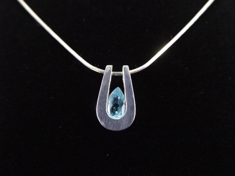 lot 9 image: .925 Sterling Silver Pear Cut Topaz Horseshoe Pendant Necklace