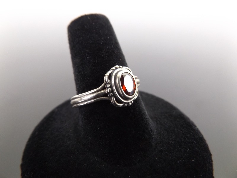 lot 28 image: .925 Sterling Silver Oval Cut Garnet Ring Size 8.5