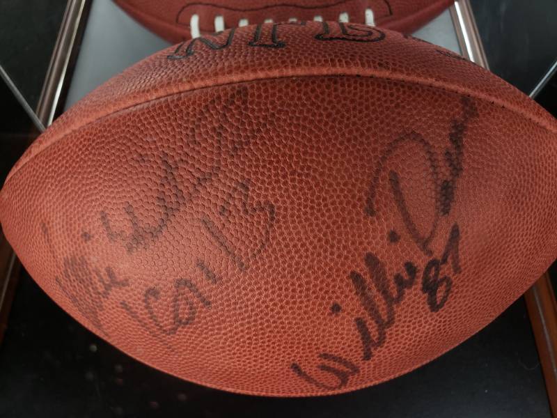lot 37 image: Reggie White & Willie Davis Dual Signed Full-Sized Football in a Deluxe Display Case