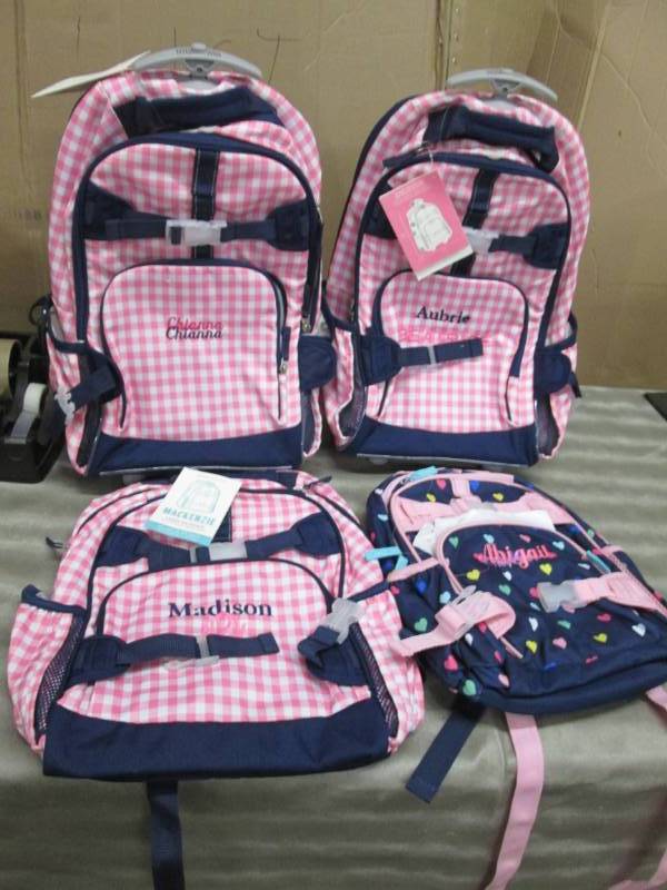 4 Pre-Personalized Back Packs...