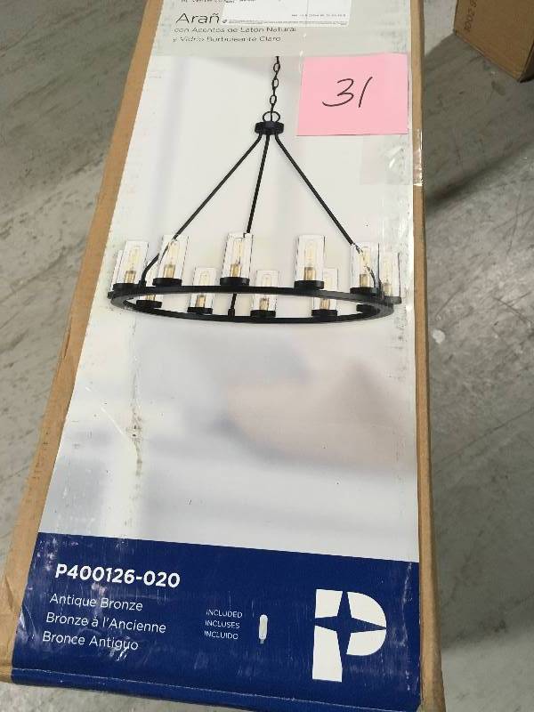 lot 31 image: Hartwell 26.63 in. 12-Light Antique Bronze Dining Room Chandelier with Clear Seeded Glass and Natural Brass Accents