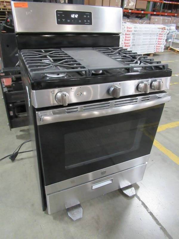 lot 12 image: GE 5-cu ft 5-Burner Freestanding Gas Range (Stainless Steel & Black) 30 JGBS66REKSS - Missing 3 Flame Caps, 1 Knob, Shelves and LH Panel is Loose.