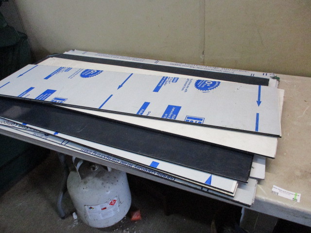 lot 55 image: Pile of plasticlexan sign blank pieces