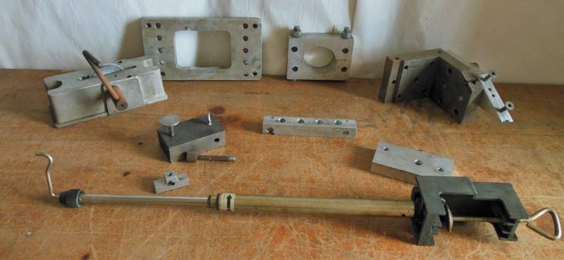 lot 26 image: Rotating Grinder Type Item in Aluminum (believed to be), Rotating Piston Item with adjustment markings, and Multiple Cast Aluminum Components