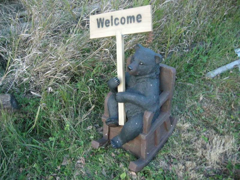 lot 47 image: Bear in Chair Holding WelcomeGo Away Sign