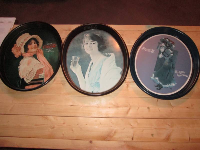 lot 22 image: Set of oval Coca Cola tins...