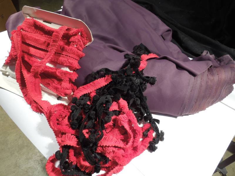 lot 81 image: Huge Bolt of Purple Fabric and Red & Black Yards of Trim