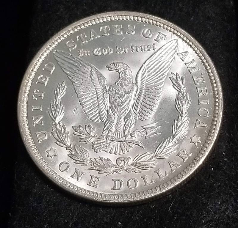 lot 34 image: 1921 MORGAN SILVER DOLLAR UNC (RIM ISSUE AT 3 OCLOCK)