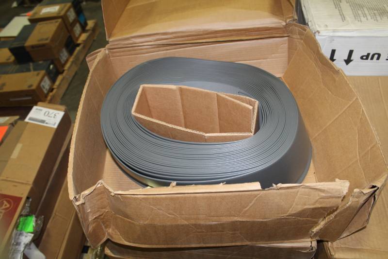 lot 379 image: Lot of (4) Boxes of VPI Wallbase CB 40 Sandstone 6x18x96LF, CB 20 Charcoal, Vinyl Toe Molding CB 18 P 6 Coil BlackBrown