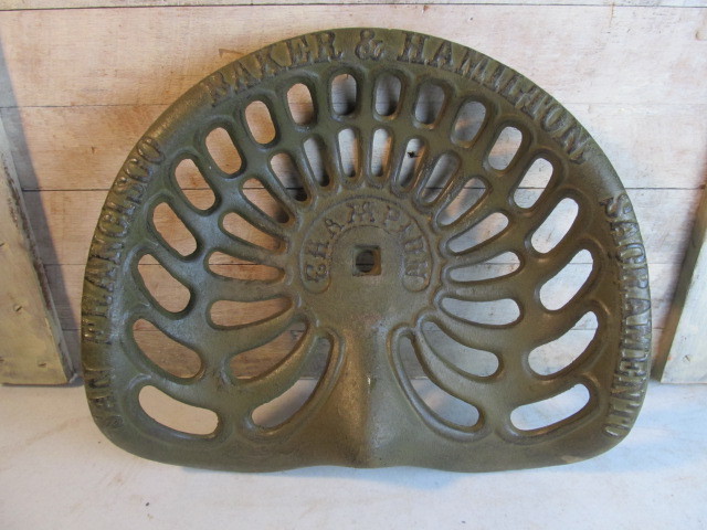 lot 37 image: Antique CHAMPION Embossed Iron Tractor Seat w City Names
