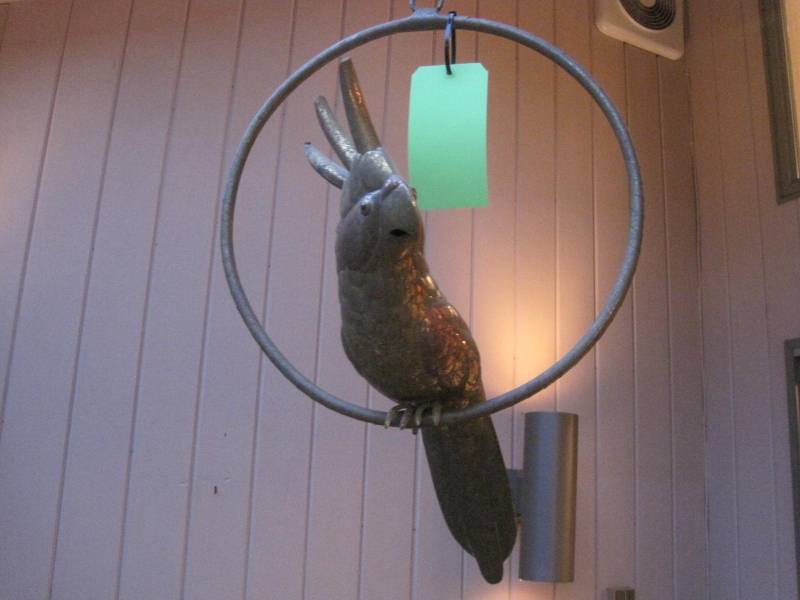 lot 20 image: A Mid Century Modern metal Parrot on ringed perch in the style of Sergio Bustamante.