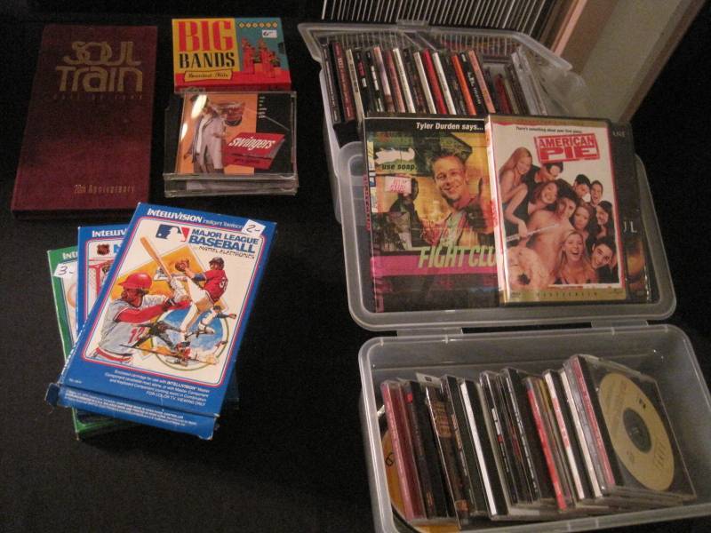 lot 49 image: Lot of Dozens of DVDs, CDs, VHS. and CD holders.