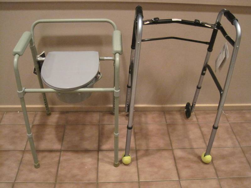 lot 29 image: Brand New With Tags. Folding Walker and Folding Commode.