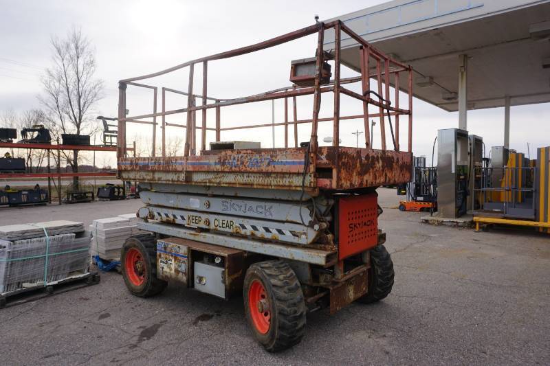 lot 10 image: 1999 Sky Jack Model SJ7027 4 x 4 Rough Terrain Scissors Lift