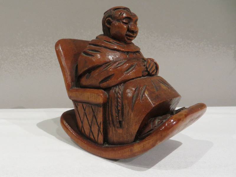 lot 44 image: Wooden monk sitting in rocking chair figurine