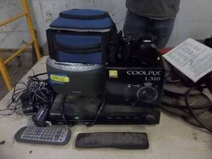 lot 180 image: Nikon Cool Pix 310 Camera With Case, Mintek DVD Player, Weather Radio