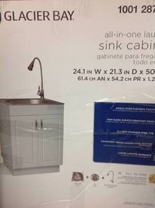 lot 121 image: Glacier Bay All-in-One 24.2 in. x 21.3 in. x 33.8 in. Stainless Steel Laundry Sink with Faucet and Storage Cabinet, High Gloss PVC Laminate QL033 not used