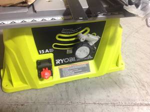 lot 143 image: RYOBI 10 in. Table Saw with Folding Stand  MISSING KEY