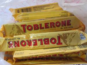 lot 234 image: 11 Toblerone Candy Bars Best by Aug...