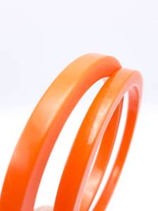 lot 62 image: (2) Vintage bakelite bangles, pair of bracelets, 1940s. Orange