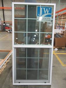 lot 314 image: Jeld-Wen 34 14 x 70 x 3 Wall, SIngle Hung Vinyl Window With Lower Screen (some fraying) and Internal Grid (Both Panes).