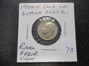 lot 73 image: Rare 1994-D Error Roosevelt Dime- Cud on Bottom of torch
