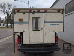 lot 1 image: Palomino Mini L Pop-Up Cab Over Truck Camper