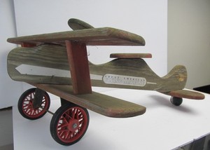lot 9 image: Rustic Wooden Ride On Airplane Toy - Great American Flying Machine