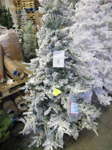 Artificial LED Tree in snow covered green, roughly 6.6 feet tall by Vickerman