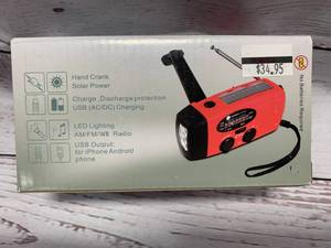 lot 124 image: Solar PoweredHand Crank Light, Cell Phone Charger, and Emergency Radio