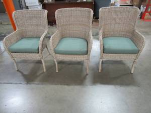 lot 211 image: 3 Hampton Bay Lemon Grove WickerResin Patio Chairs. - One Chair has a leg unraveled.