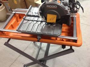 lot 68 image: Ridgid 9 Amp Corded 7 in. Wet Tile Saw with Stand USED in good condition