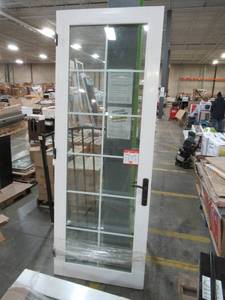 lot 341 image: Millgard 12 lite, Full Window, Internal Grill, Low-E Argon Filled Vinyl Patio Door 33 12 X 92 12 Tall in White With Black Handles and Hinges.