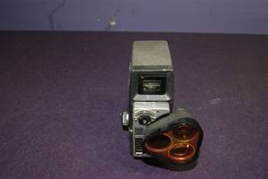 lot 25 image: Movie Camera Vintage Bell & Howell Model 393 with 3 Lens Turrent, Filter