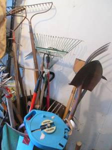 Metal barrel full of yard tools...