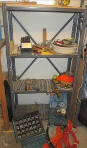 Metal shelf full of hand tools, har...