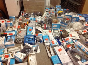 lot 150 image: Lot with assorted Moen Bathroom Accessories, shower heads and more open boxes some maybe missing parts