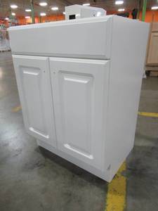 lot 232 image: Project Source White Single Sink Vanity Cabinet 24 X 18 X 32 Tall. BAC VBCU2418 Cracked on LH Side.