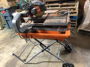 lot 2005 image: RIDGID 10 in. Wet Tile Saw with Stand in really good working conditions